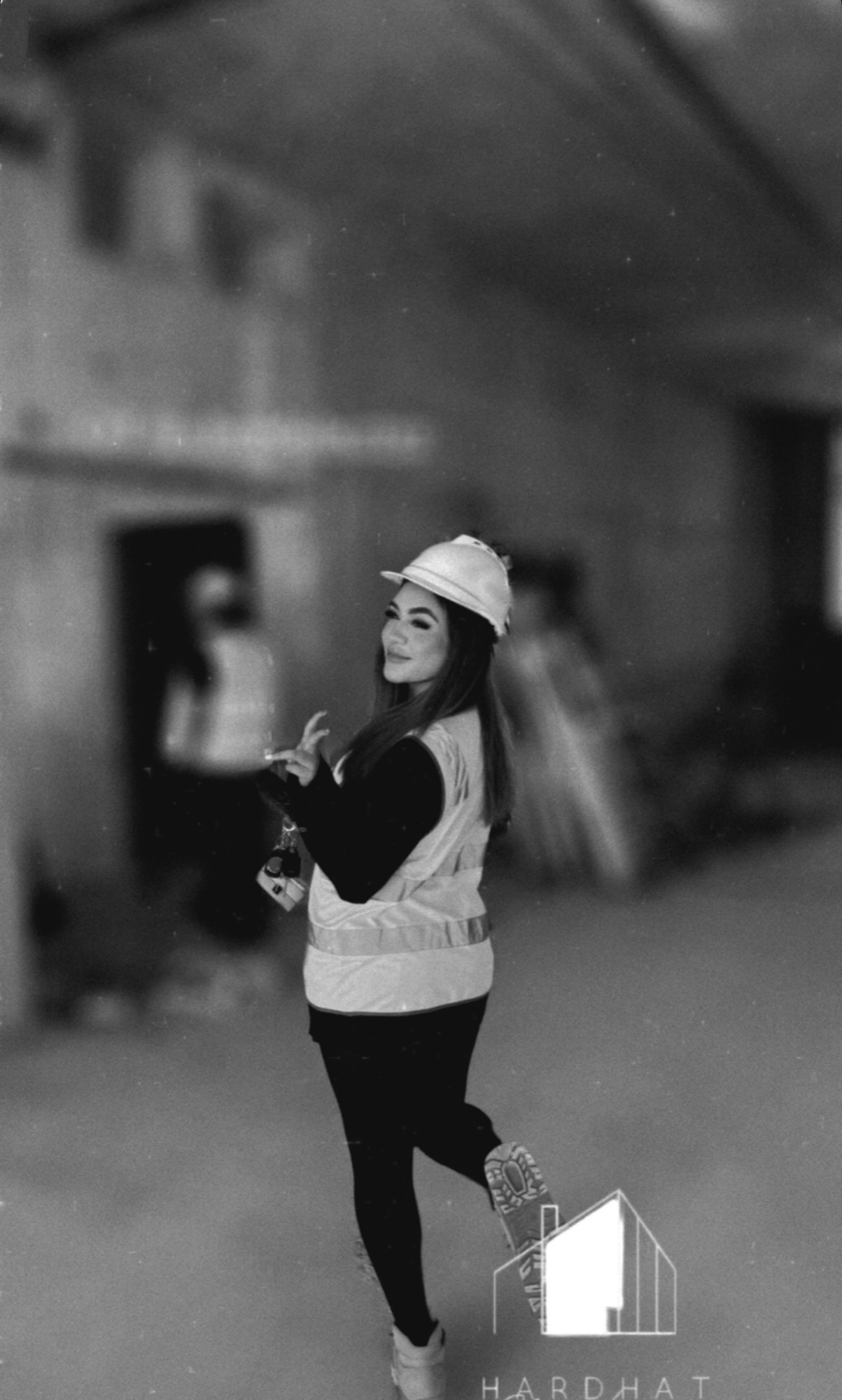 Cheyenne on a construction site in a hard hat and safety vest